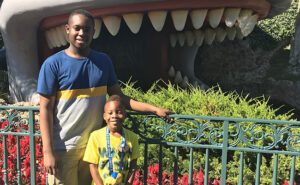 Father and son in front of Disney whale of Storybook Land Canal in California Disneyland