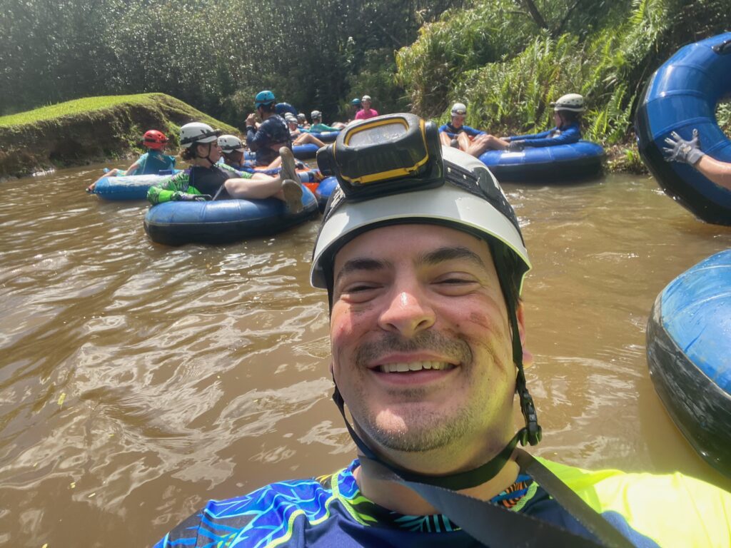 Lisa & Rob McKenzie with son Ian in Princeville on Kauai island Hawaii man tubing down old sugar cane canals wearing headlamp for manmade tunnels